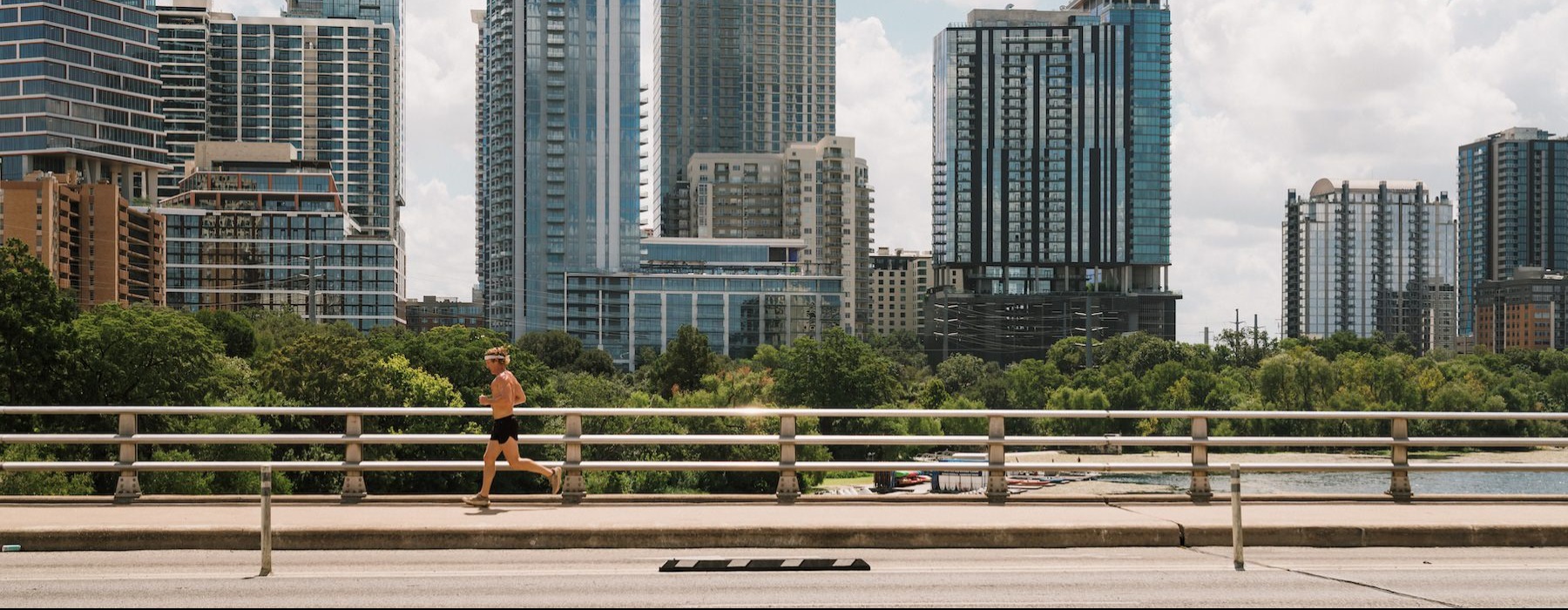 a person running on a bridge in a city