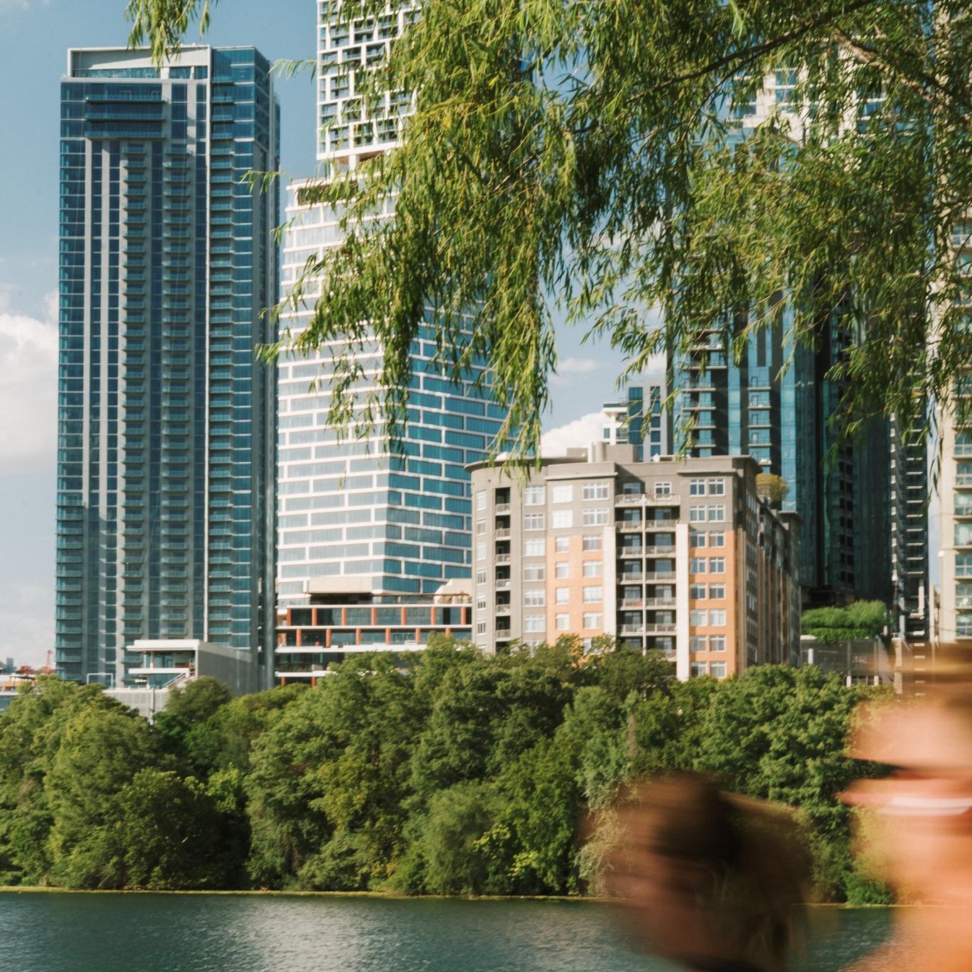 a body of water with trees and buildings around it